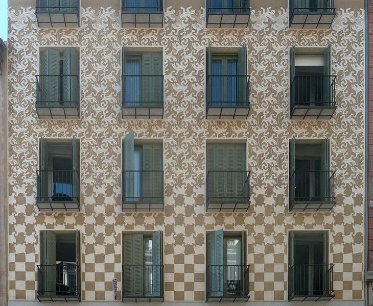 Facade decorated showing an Escher's design from Metamorphosis II.