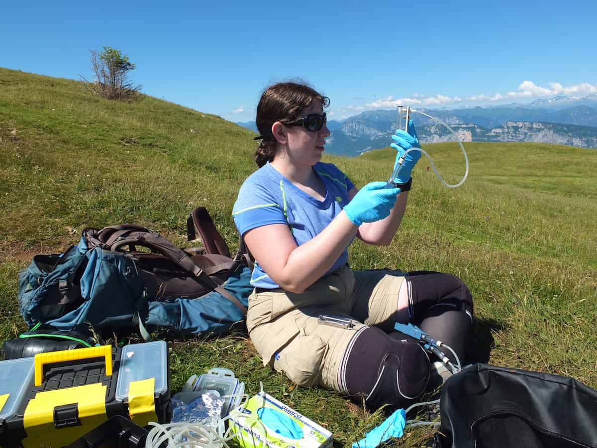 Kelsey Byers using scientific equipment in the field.