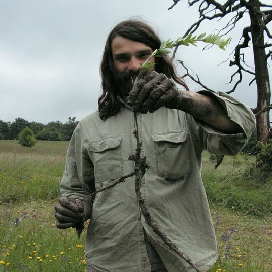 A chap holding a stalk of grass