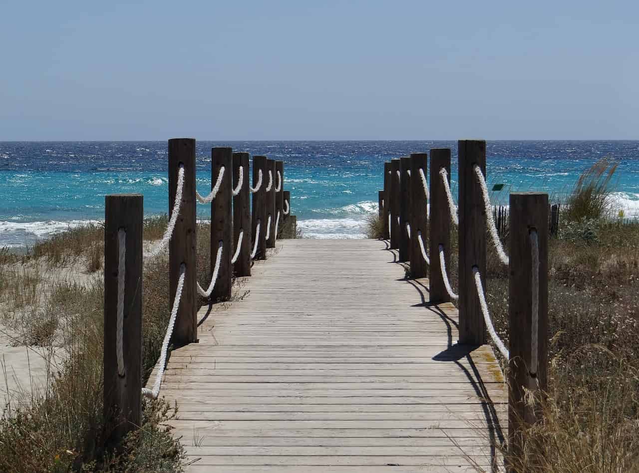 A wooden wayway leading to the sea throughj dunes on Menorca