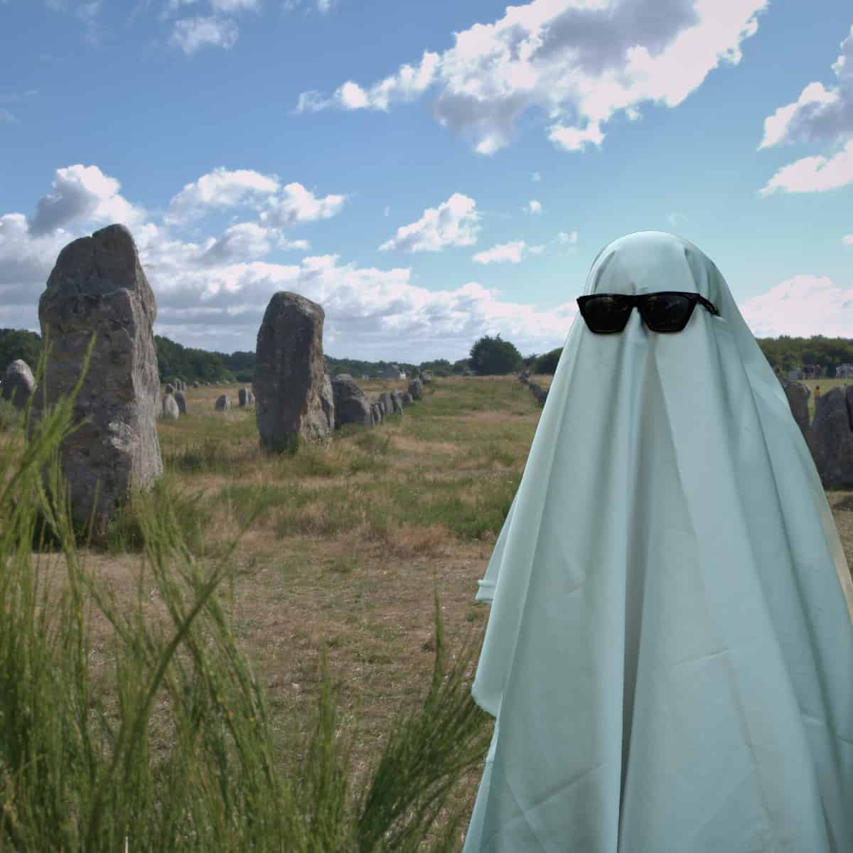 A ghost standing by some megaliths in Brittany.