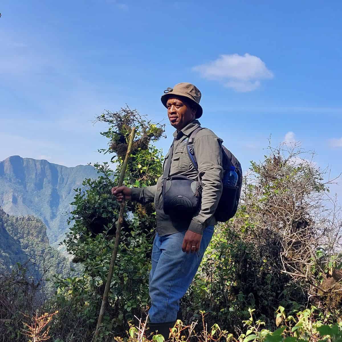 Paul Kirika standing out in vegetation.